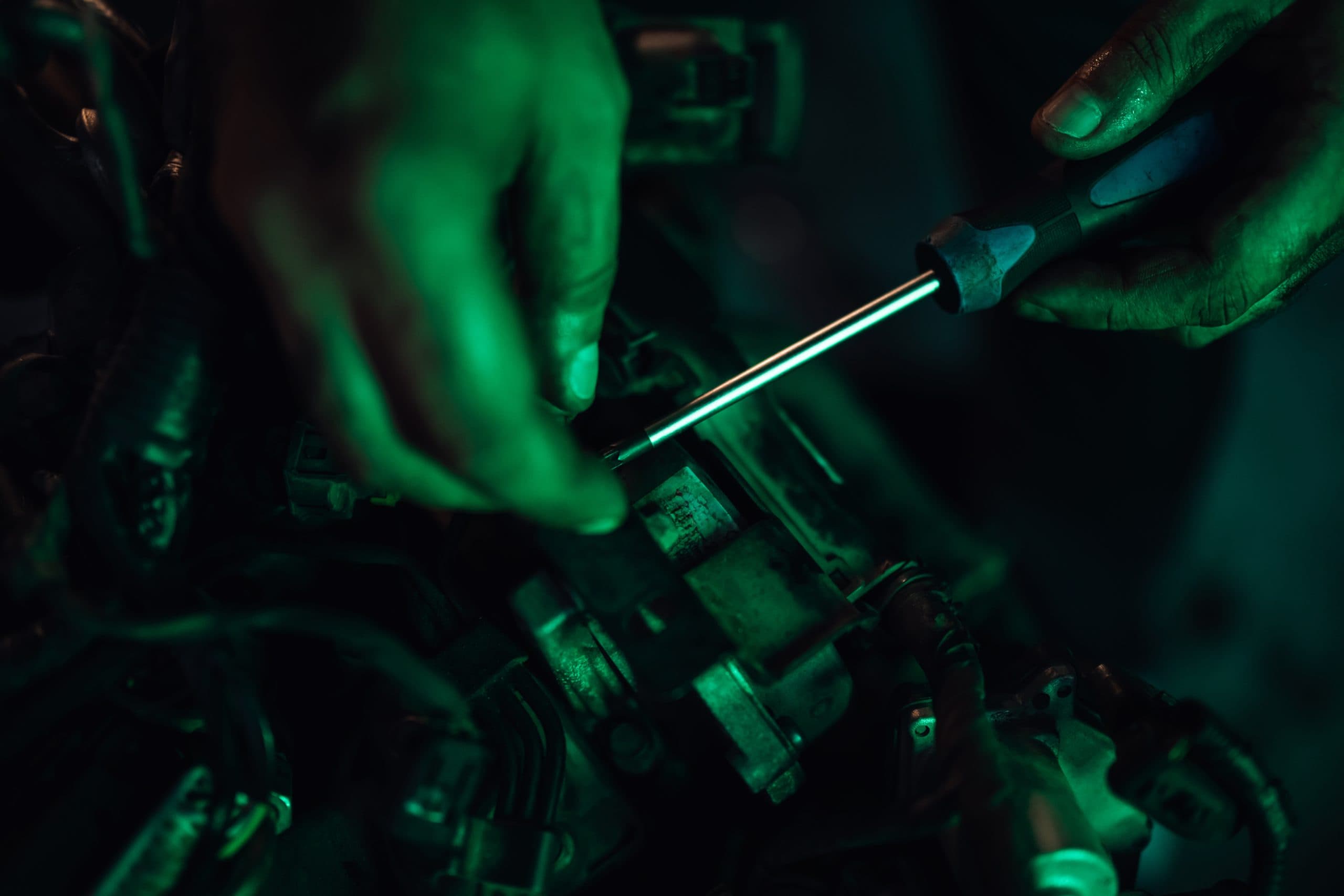Mechanic hands working on car parts with precision tools