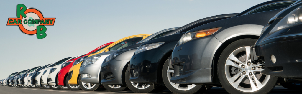 Customer exploring a selection of used vehicles lined up outside R&B Car Company in Warsaw, Indiana
