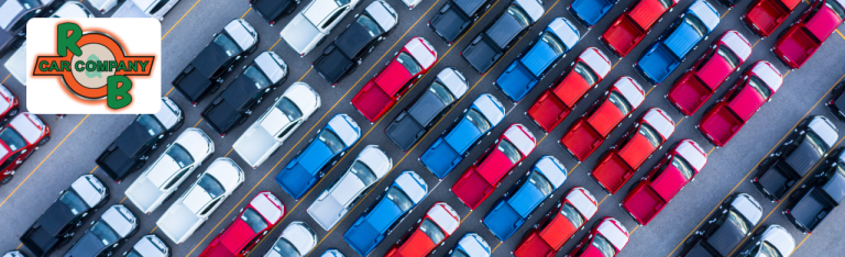 Pre-owned Ford F-150 and Chevy Silverado trucks parked outside R&B Car Company Warsaw dealership.