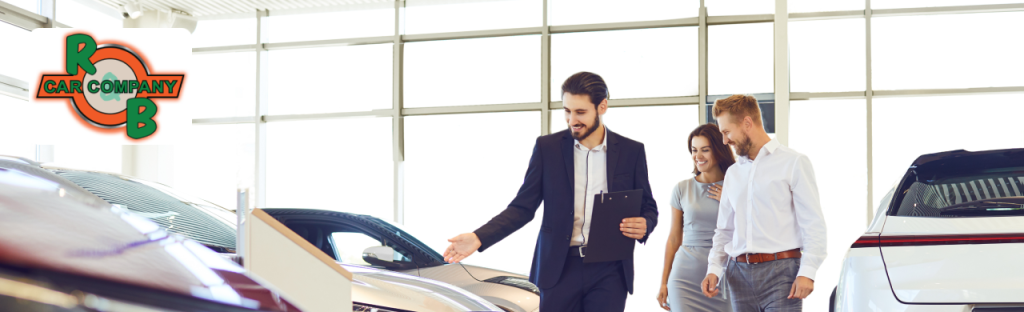 Sales team assisting a customer with financing and trade-in options at R&B Car Company, Warsaw
