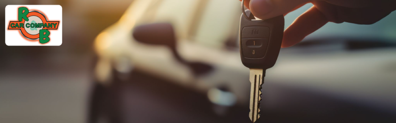 Customer speaking with a sales associate while browsing vehicles at R&B Car Company Warsaw showroom.